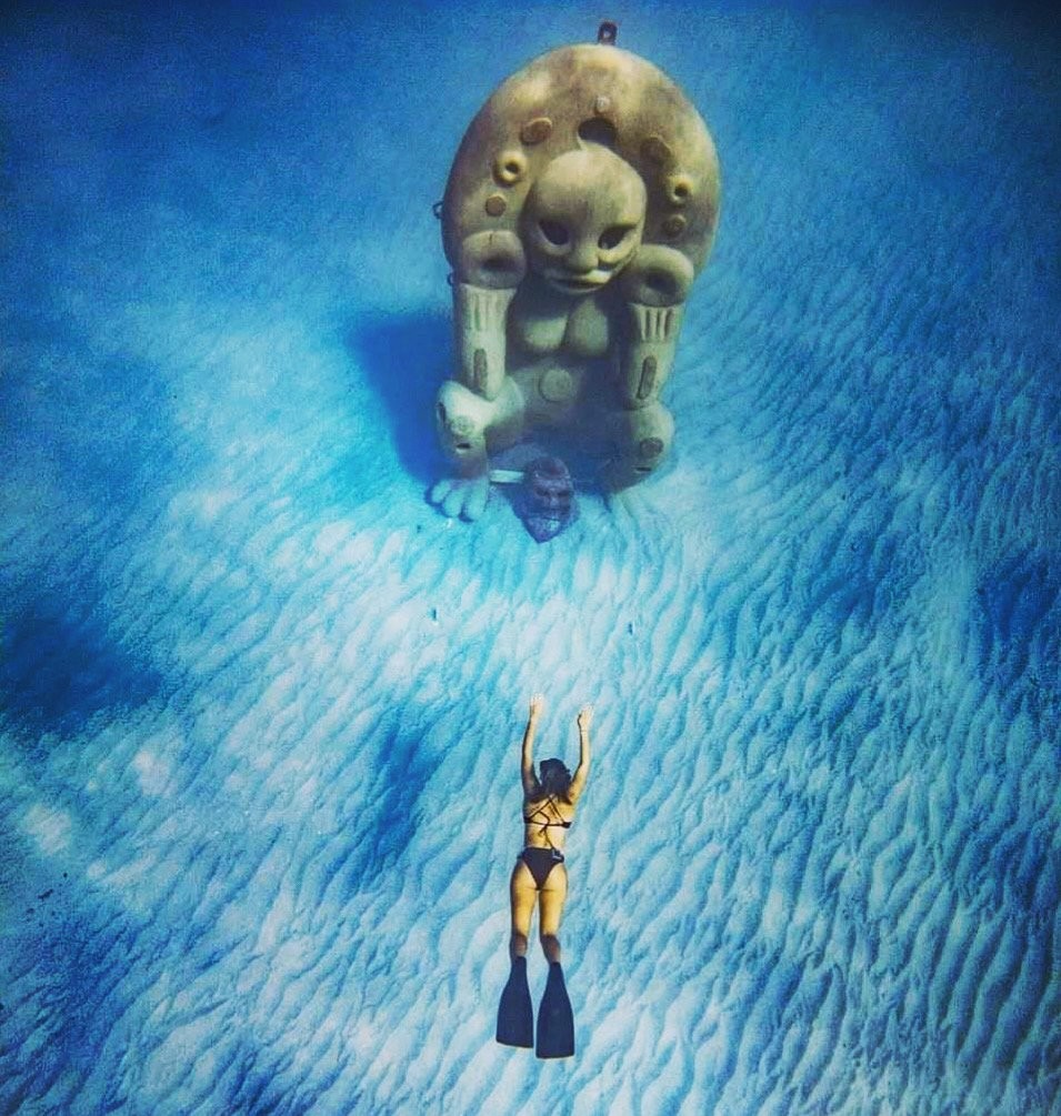 An underwater sculpture by Global Coralition, lit by rays of sunlight